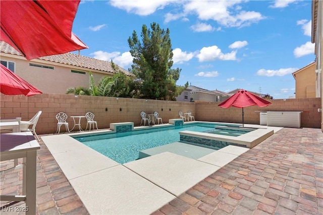 view of pool with a fenced in pool, an in ground hot tub, a patio area, and a fenced backyard