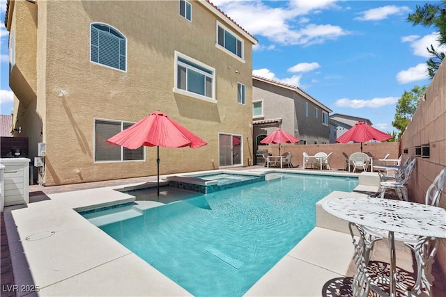 view of pool with a fenced backyard, outdoor dining area, a pool with connected hot tub, and a patio area