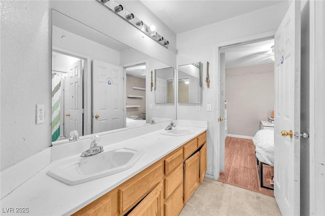 2753 Trickling Brook Ct, Las Vegas, NV 89156 - ensuite bathroom with double vanity and baseboards