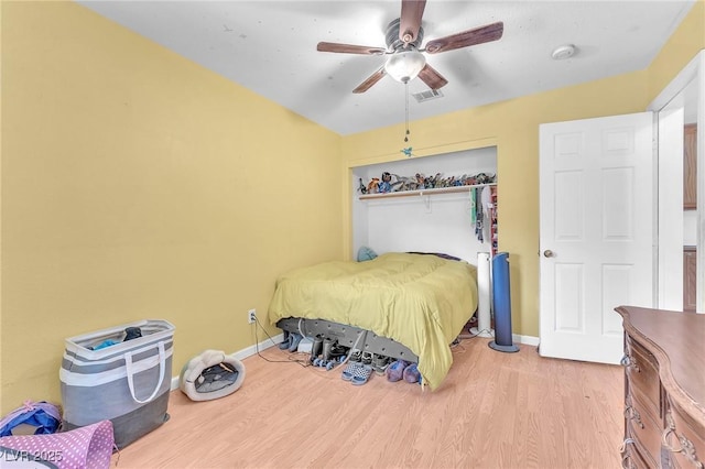 2753 Trickling Brook Ct, Las Vegas, NV 89156 - bedroom with light wood-style flooring, baseboards, a ceiling fan, and a closet