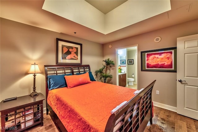 150 Las Vegas Blvd Unit 1606, Las Vegas, NV 89101 - bedroom with baseboards, ensuite bath, and wood finished floors