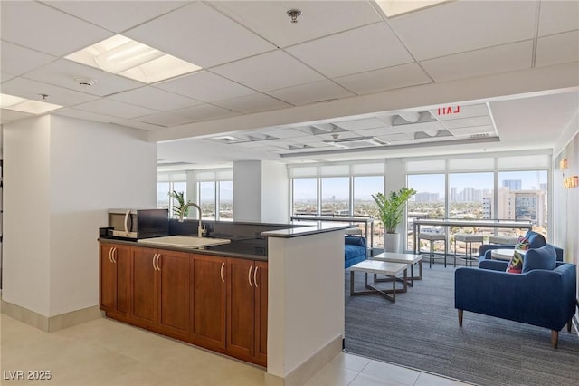 150 Las Vegas Blvd Unit 1606, Las Vegas, NV 89101 - kitchen with dark countertops, open floor plan, light colored carpet, stainless steel microwave, and a sink