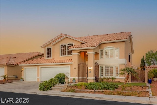 3950 Candleglow Ct, Las Vegas, NV 89147 - mediterranean / spanish-style house featuring a gate, stucco siding, a tiled roof, and driveway