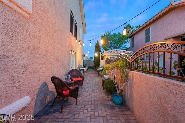 3950 Candleglow Ct, Las Vegas, NV 89147 - view of side of property with fence, a patio, stucco siding, and a tiled roof