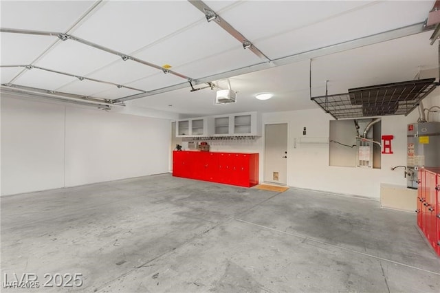 3950 Candleglow Ct, Las Vegas, NV 89147 - garage featuring heating unit, strapped water heater, and a garage door opener