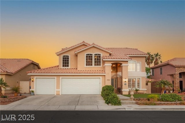 3950 Candleglow Ct, Las Vegas, NV 89147 - mediterranean / spanish house featuring a tiled roof, an attached garage, driveway, and stucco siding