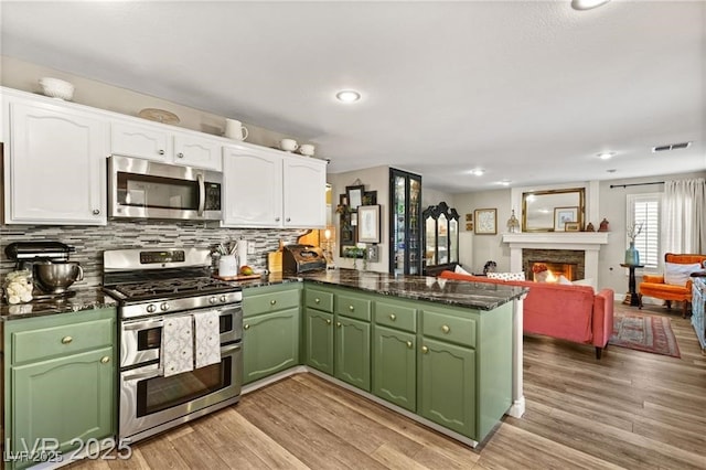 3950 Candleglow Ct, Las Vegas, NV 89147 - kitchen featuring green cabinetry, stainless steel appliances, a peninsula, and white cabinetry