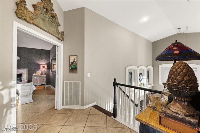 3950 Candleglow Ct, Las Vegas, NV 89147 - hall with light tile patterned flooring, baseboards, an upstairs landing, lofted ceiling, and visible vents