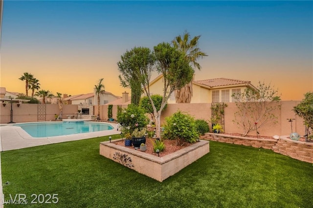 3950 Candleglow Ct, Las Vegas, NV 89147 - pool at dusk featuring a fenced in pool, a fenced backyard, and a yard