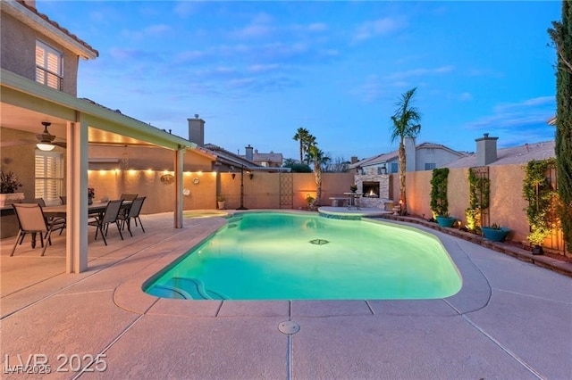 3950 Candleglow Ct, Las Vegas, NV 89147 - view of swimming pool featuring an outdoor stone fireplace, a patio, a fenced in pool, and a fenced backyard