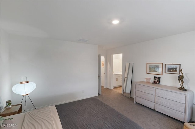 bedroom featuring connected bathroom, baseboards, light colored carpet, and visible vents