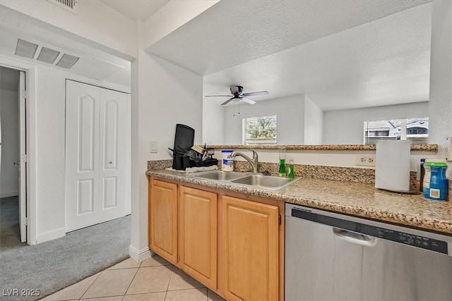 kitchen featuring ceiling fan, light colored carpet, dishwasher, a sink, and light countertops