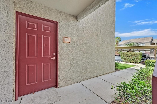 doorway to property with stucco siding