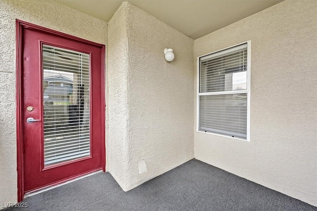 property entrance with stucco siding