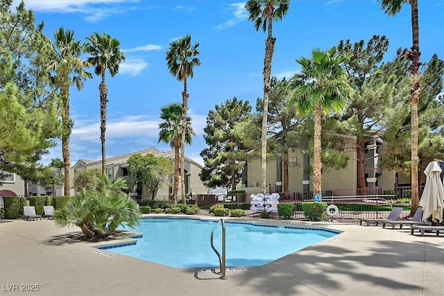pool featuring fence and a patio area