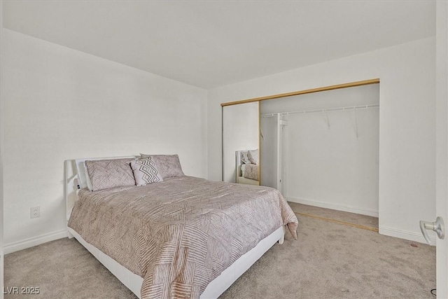 carpeted bedroom with baseboards and a closet