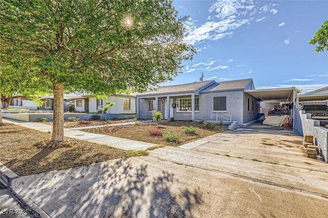 517 7th St, Boulder City, NV 89005 - view of front of home featuring a carport, stucco siding, and concrete driveway