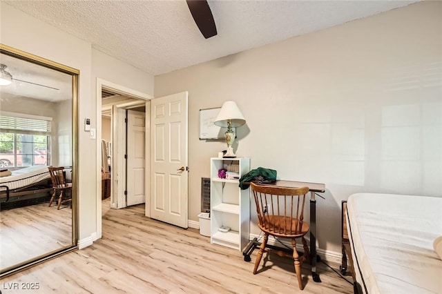 517 7th St, Boulder City, NV 89005 - sitting room with light wood-style flooring, a ceiling fan, a textured ceiling, and baseboards