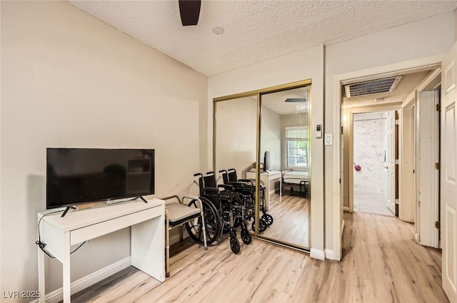 517 7th St, Boulder City, NV 89005 - interior space featuring light wood-style floors, a textured ceiling, a ceiling fan, and baseboards