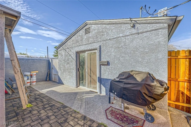517 7th St, Boulder City, NV 89005 - rear view of house with stucco siding, a patio area, and a fenced backyard