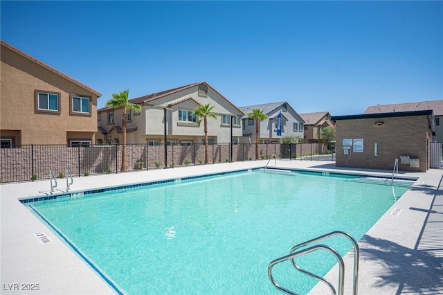 community pool with a residential view and fence