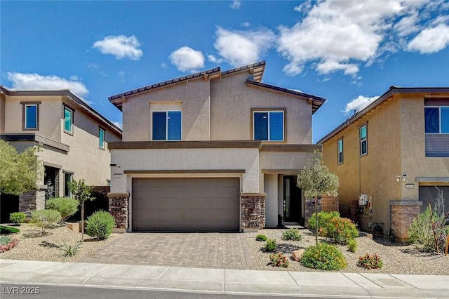 8898 Sasquatch Run Ave, Las Vegas, NV 89166 - view of front of property with an attached garage, driveway, stucco siding, and stone siding
