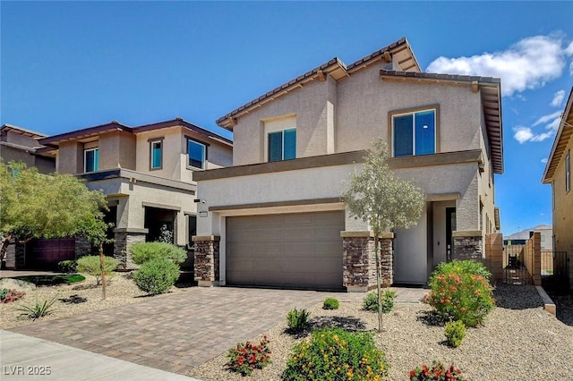 8898 Sasquatch Run Ave, Las Vegas, NV 89166 - view of front of home with stone siding, a garage, stucco siding, a gate, and decorative driveway