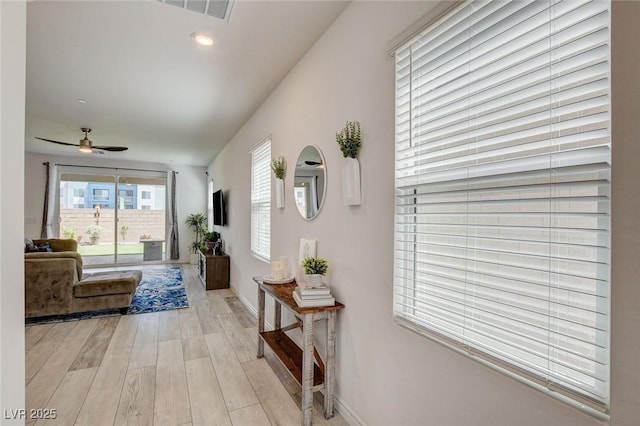8898 Sasquatch Run Ave, Las Vegas, NV 89166 - hall featuring light wood-style floors, baseboards, and visible vents