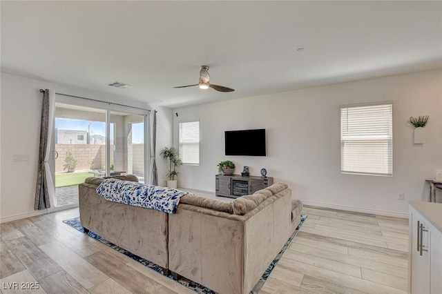 8898 Sasquatch Run Ave, Las Vegas, NV 89166 - living area with visible vents, a ceiling fan, light wood finished floors, and baseboards
