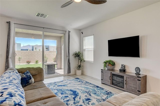 8898 Sasquatch Run Ave, Las Vegas, NV 89166 - living room featuring baseboards, ceiling fan, wood finished floors, and visible vents