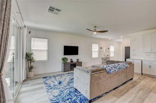 8898 Sasquatch Run Ave, Las Vegas, NV 89166 - living area featuring a ceiling fan, visible vents, plenty of natural light, and light wood-type flooring