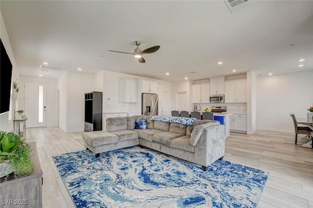 8898 Sasquatch Run Ave, Las Vegas, NV 89166 - living room featuring baseboards, a ceiling fan, light wood finished floors, and visible vents