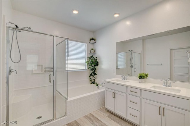 8898 Sasquatch Run Ave, Las Vegas, NV 89166 - full bathroom with double vanity, a shower stall, a sink, and a garden tub