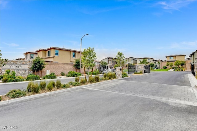 8898 Sasquatch Run Ave, Las Vegas, NV 89166 - view of street featuring street lights, a residential view, a gate, and curbs