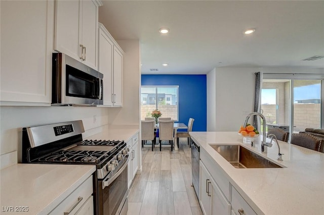 8898 Sasquatch Run Ave, Las Vegas, NV 89166 - kitchen featuring visible vents, a sink, recessed lighting, and stainless steel appliances