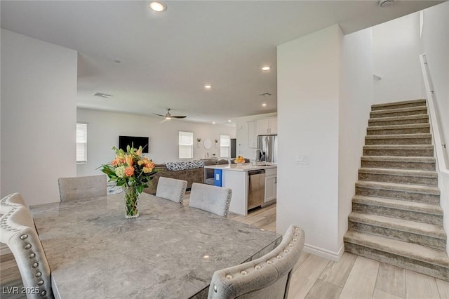 8898 Sasquatch Run Ave, Las Vegas, NV 89166 - dining area featuring recessed lighting, ceiling fan, light wood finished floors, and stairway