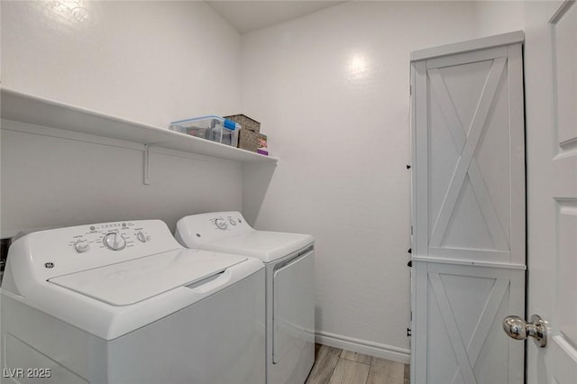 8898 Sasquatch Run Ave, Las Vegas, NV 89166 - washroom with separate washer and dryer, baseboards, laundry area, and light wood finished floors