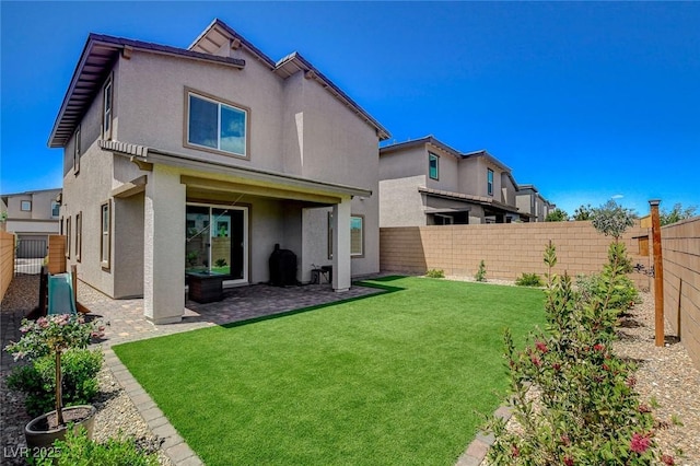8898 Sasquatch Run Ave, Las Vegas, NV 89166 - rear view of house with a fenced backyard, stucco siding, a lawn, and a patio area