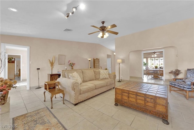 3065 S Torrey Pines Dr, Las Vegas, NV 89146 - living area with ceiling fan, arched walkways, light tile patterned flooring, and vaulted ceiling