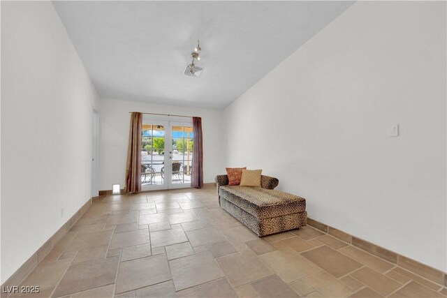 3065 S Torrey Pines Dr, Las Vegas, NV 89146 - living area featuring french doors, stone tile floors, and baseboards