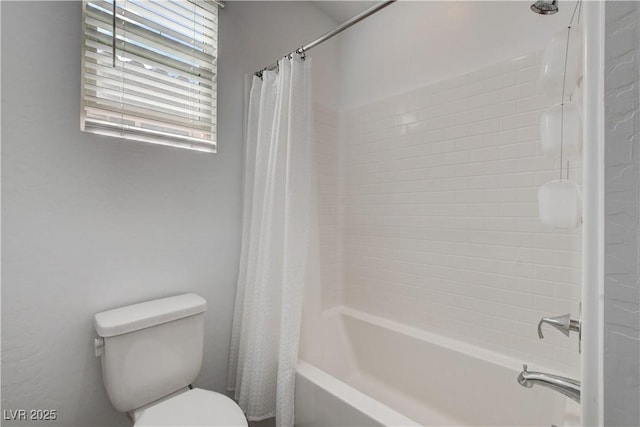 bathroom featuring toilet and shower / bath combination with curtain