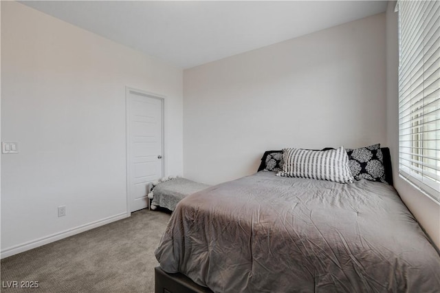 carpeted bedroom featuring baseboards