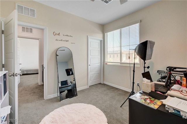 interior space with visible vents, baseboards, and light carpet