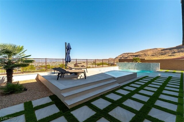 5436 Succulent Rose Dr, Las Vegas, NV 89135 - view of patio / terrace with a fenced in pool, a fenced backyard, a jacuzzi, and a mountain view