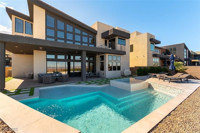 5436 Succulent Rose Dr, Las Vegas, NV 89135 - back of house featuring a patio, stucco siding, a balcony, and an outdoor hangout area