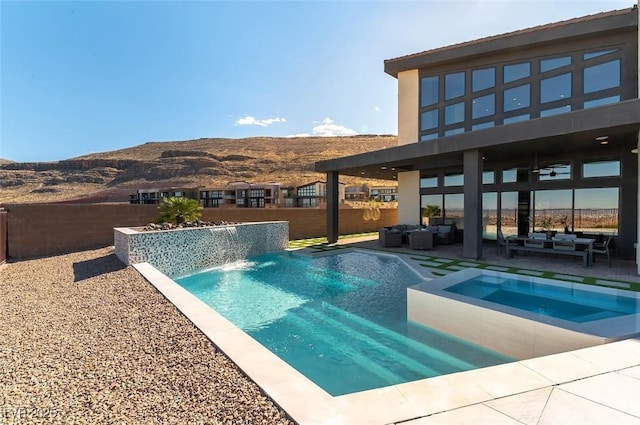 5436 Succulent Rose Dr, Las Vegas, NV 89135 - view of pool with outdoor lounge area, a fenced backyard, a fenced in pool, a patio area, and a mountain view