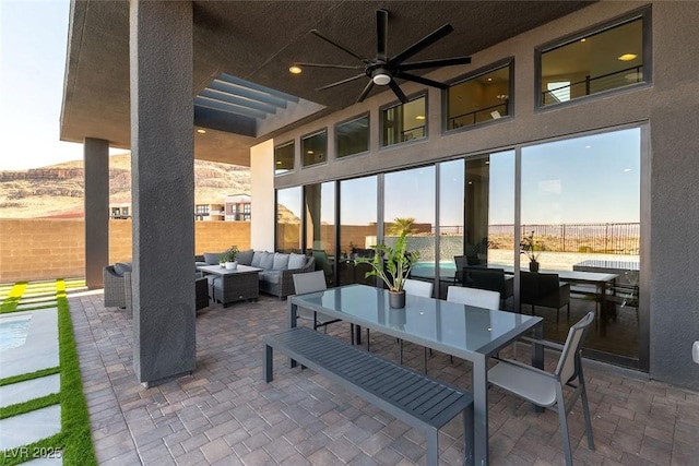 5436 Succulent Rose Dr, Las Vegas, NV 89135 - view of patio / terrace featuring fence, outdoor lounge area, and a ceiling fan