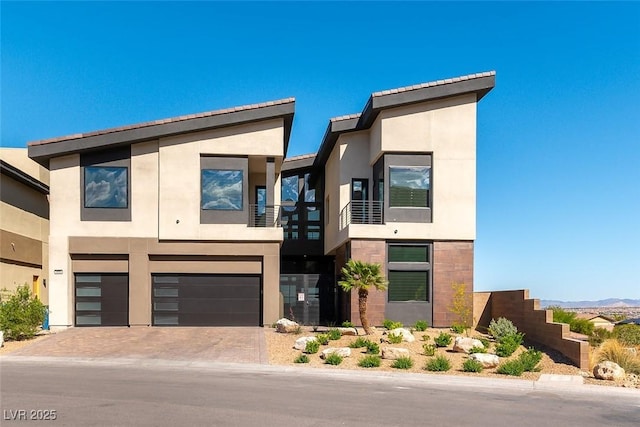 5436 Succulent Rose Dr, Las Vegas, NV 89135 - contemporary house with a garage, driveway, a balcony, and stucco siding