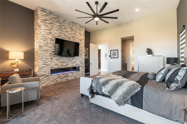5436 Succulent Rose Dr, Las Vegas, NV 89135 - carpeted bedroom featuring ceiling fan, a fireplace, and visible vents