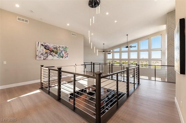 5436 Succulent Rose Dr, Las Vegas, NV 89135 - corridor with visible vents, wood finished floors, baseboards, recessed lighting, and an upstairs landing